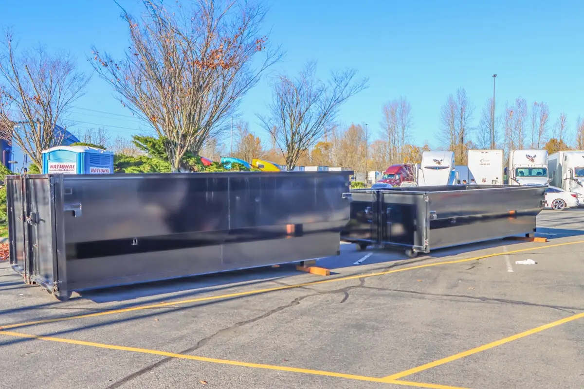 Professional dumpster rental service with roll-off container on residential driveway in Cedar Mill